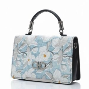 Close-up of blue floral jacquard bag with silver logo